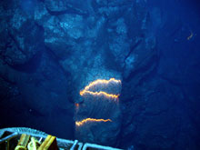 The orange glow of superheated magma, about 2,200 degrees Fahrenheit, is exposed as pillow lavas extrude from the eruption.