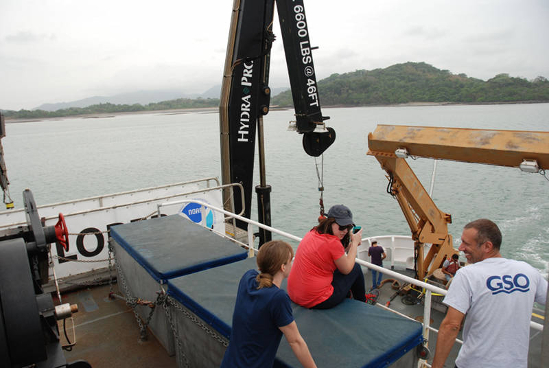 Explorers in Training Abigail Casavant (middle) and Mike Barber (right) are given a ship orientation by Expedition Coordinator Lindsay McKenna (left) as NOAA Ship Okeanos Explorer left the Panama Canal.